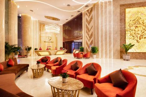Regalia Gold Hotel lobby with reception desk and seating area.