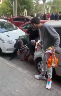 People assisting a person on the ground.