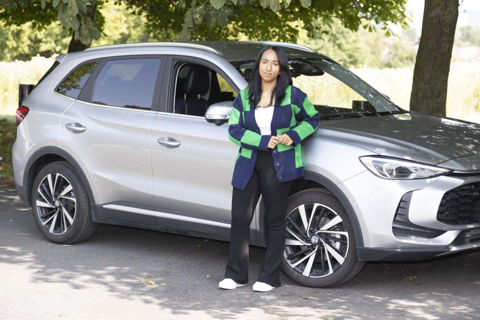 Simone Baron standing next to a silver SUV.