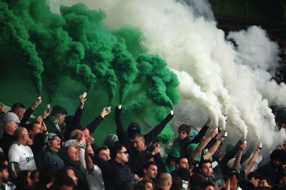 Sporting CP fans using smoke flares at a soccer match.