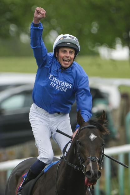 Jockey William Buick celebrates a win.