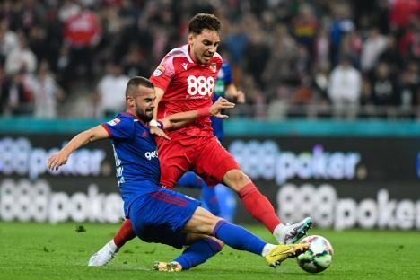 Two soccer players vying for the ball during a match.