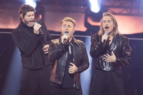 Take That performing on stage.
