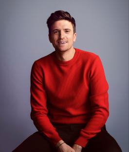 Greg James in a red sweater.