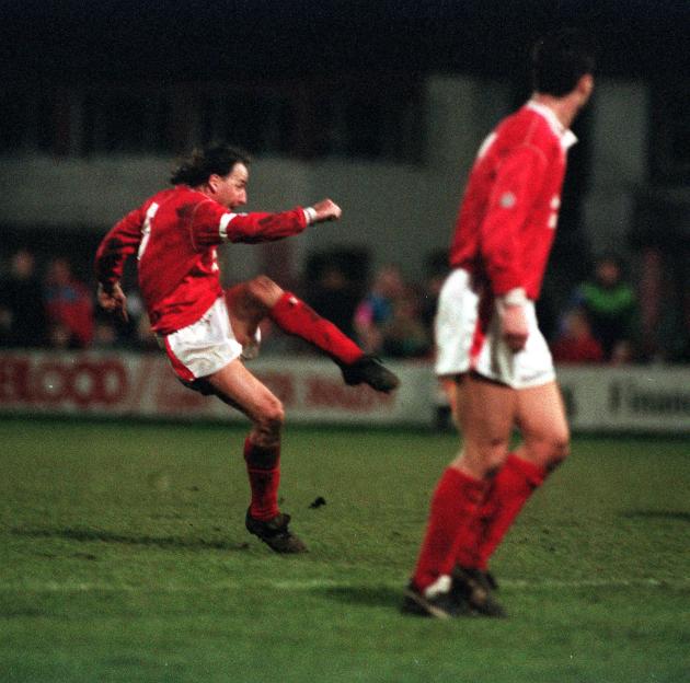 Mickey Thomas, Wrexham captain, kicking the ball during a football match.