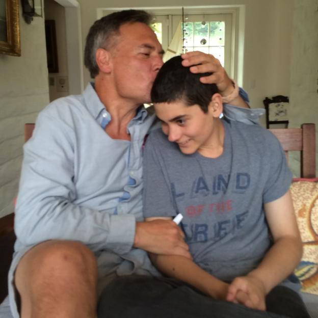 A father kissing his son on the head.