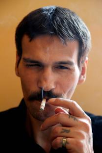 Close-up of a man smoking a cigarette.