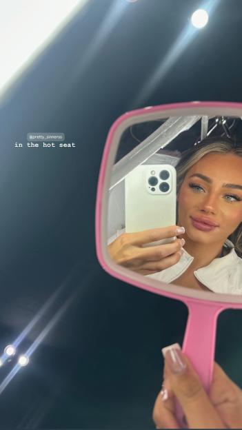 Woman taking a selfie in a mirror.