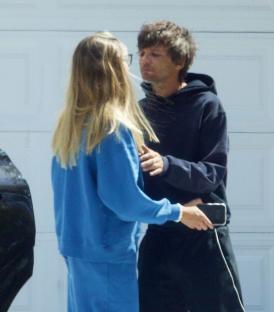 Louis Tomlinson and Zara McDermott sharing a moment.
