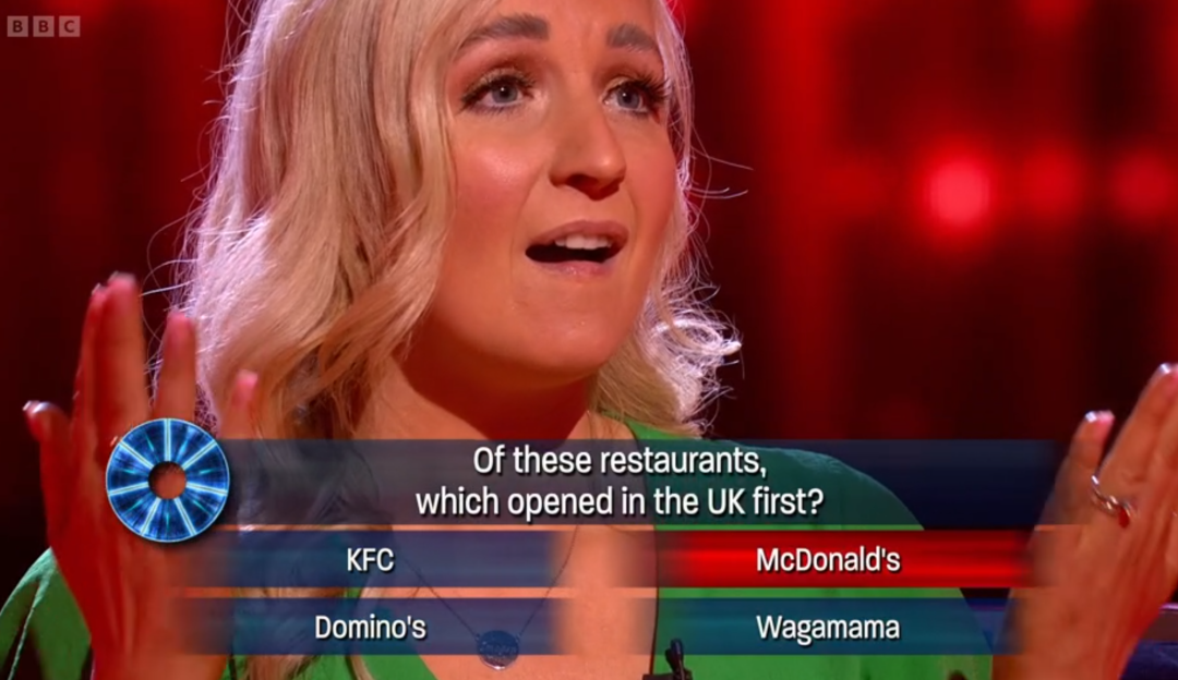 A contestant on a game show answers a question about which restaurant opened first in the UK.
