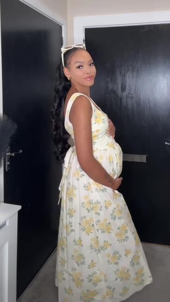 Pregnant woman in floral dress.