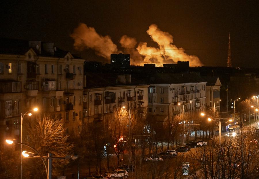Smoke billows over a city at night after a Russian drone strike.
