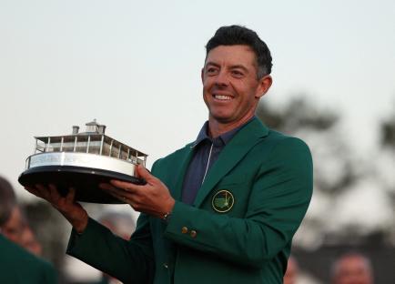 Rory McIlroy holding the Masters Tournament trophy and wearing the green jacket.