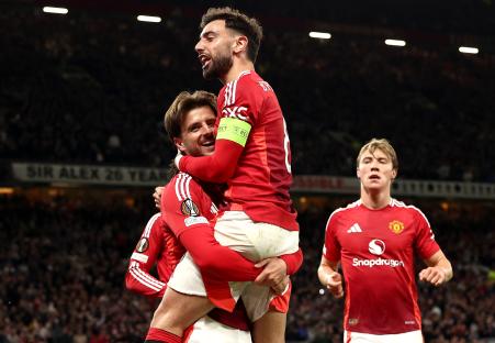 Manchester United's Bruno Fernandes celebrates a goal with Mason Mount.