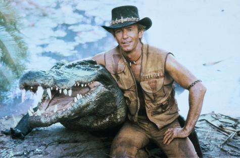 Paul Hogan with a crocodile in a scene still from *Crocodile Dundee*.