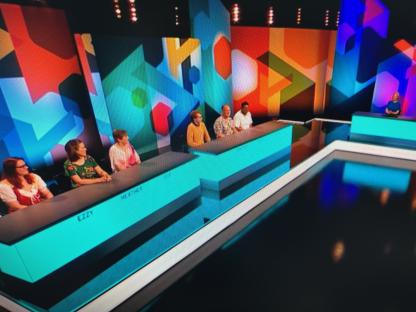 Contestants on the game show Puzzling.