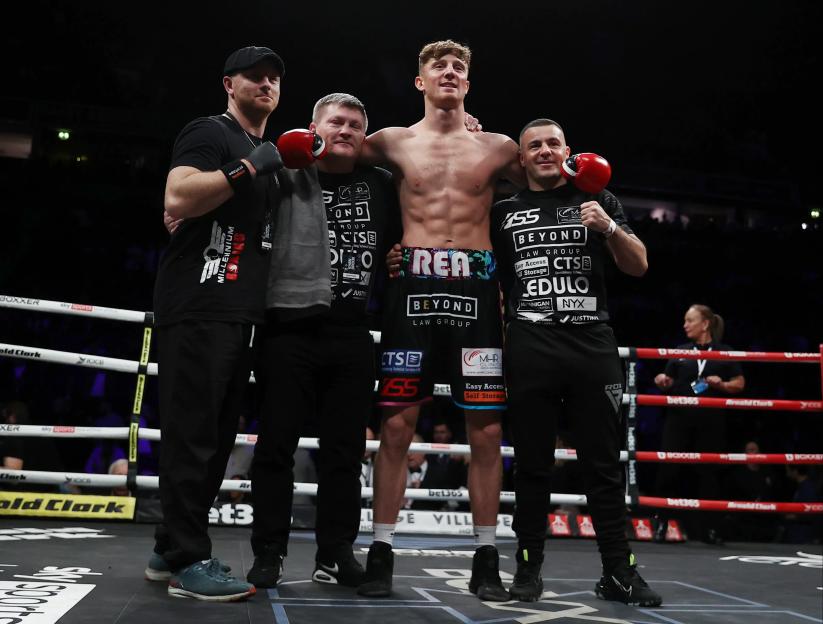 Brad Rea celebrating his middleweight contest win with his team.