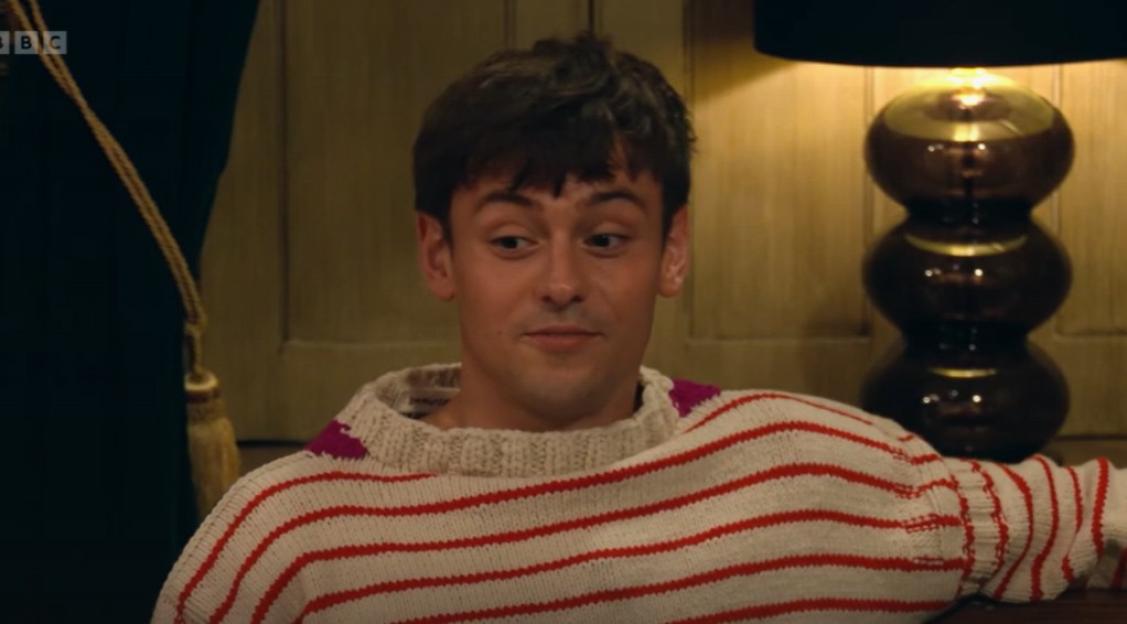 Tom Daley in a striped sweater.