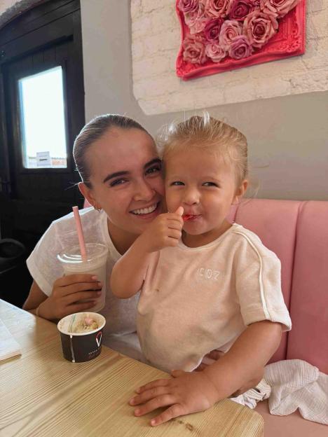 Woman and toddler enjoying ice cream.