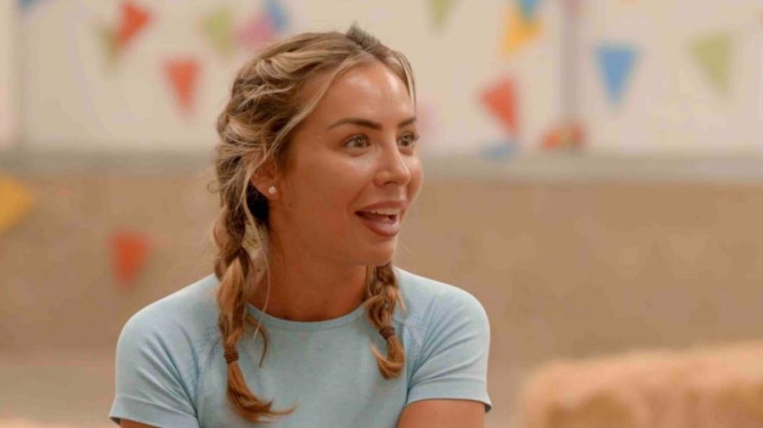 Woman with blonde hair in pigtails smiling.