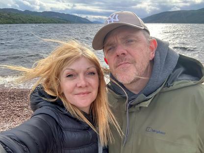Selfie of a couple by a lake.