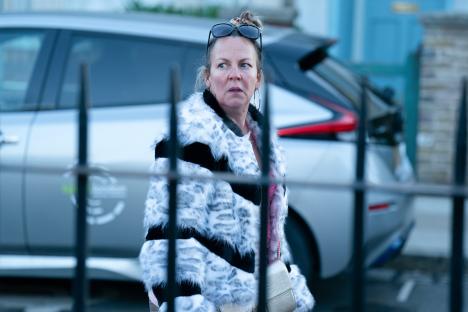 Karen Taylor from EastEnders wearing a leopard print coat.