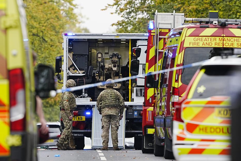 Two army members with a bomb disposal robot at the scene of an incident at Heaton Park Hebrew Congregation synagogue.