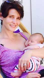 Woman holding sleeping baby.