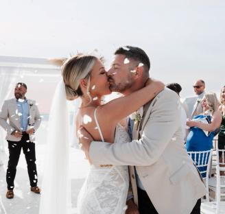 Bride and groom kissing at their wedding ceremony.