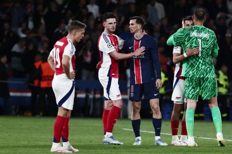 A PSG player comforts an Arsenal player after a Champions League match.