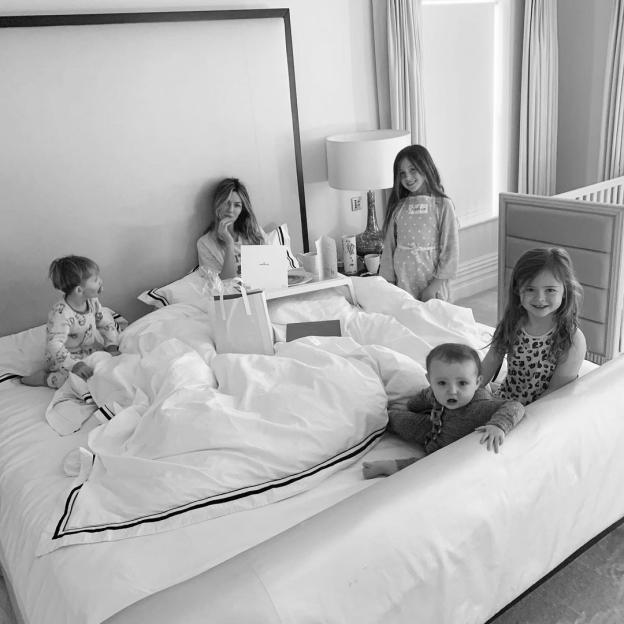 Abbey Clancy in bed with her children.