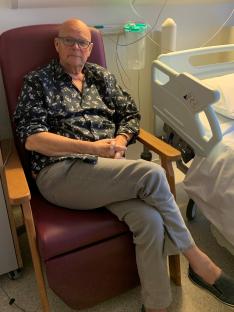 Man sitting in a hospital chair.