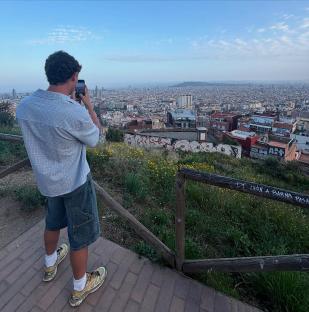 Person taking a photo of Barcelona cityscape.