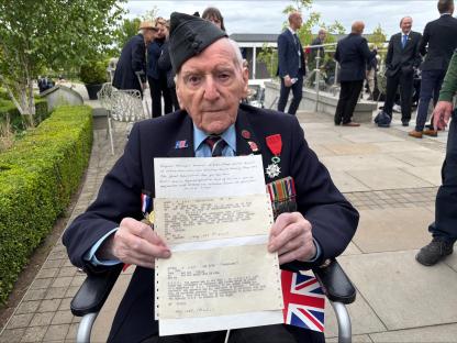 A veteran holding telegrams announcing the end of WWII.