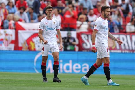 Two Sevilla FC soccer players on the field.