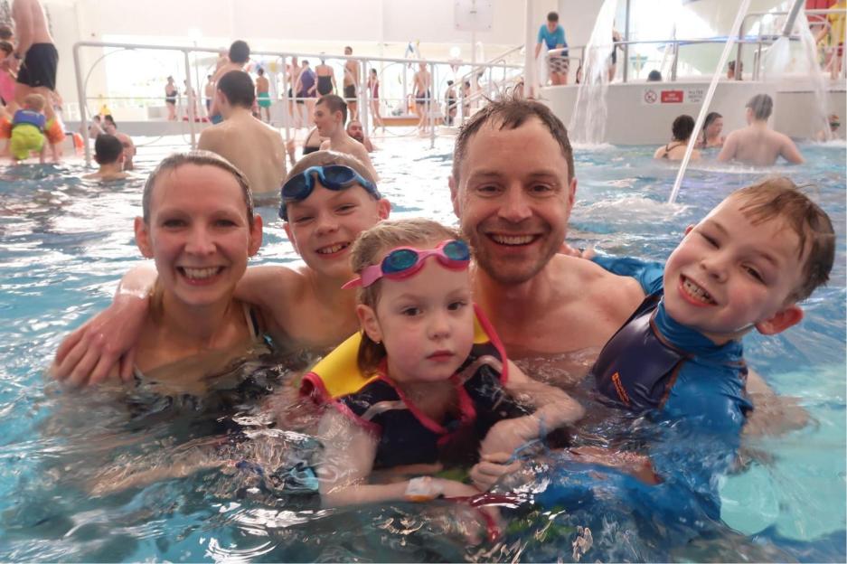 Family in a swimming pool.
