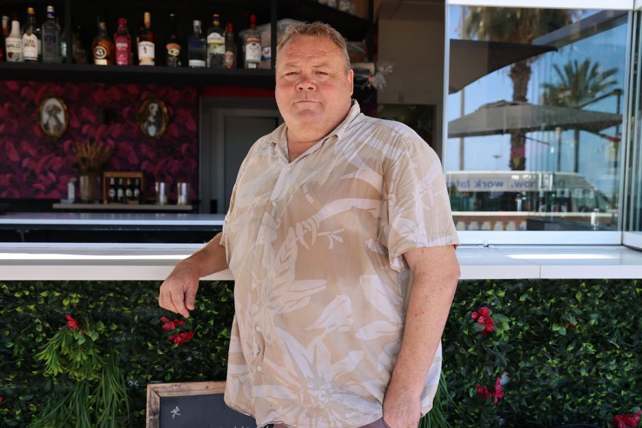 A man stands at a bar.