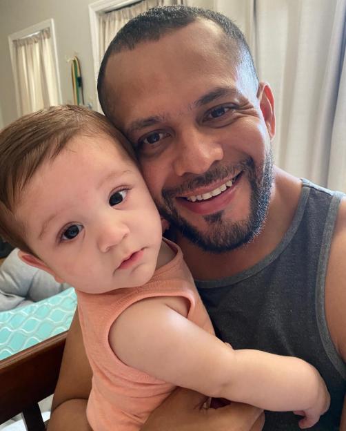A father holding his baby son.