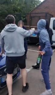 A confrontation between several people in a parking lot.