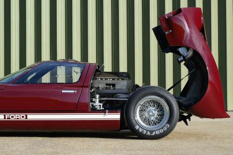 Restored 1965 Ford GT40 race car with engine exposed.