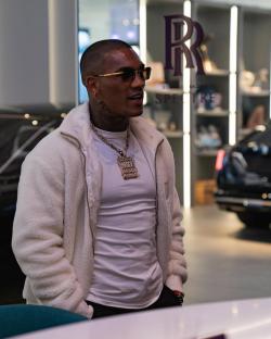 Conor Benn wearing a white jacket and sunglasses.