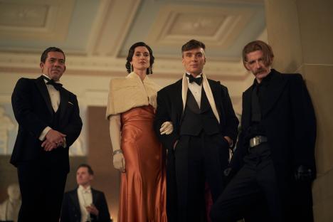 Scene from Peaky Blinders featuring four characters in formal attire.