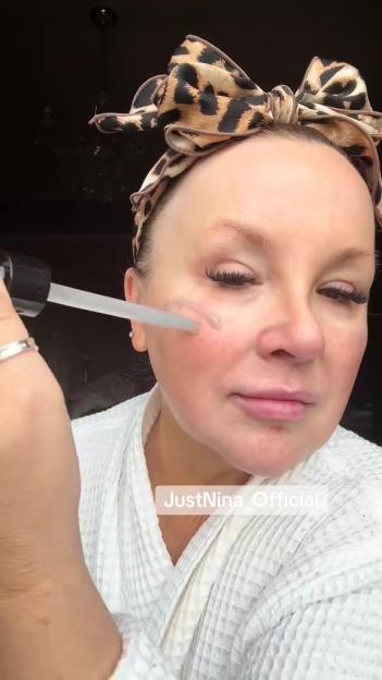 Woman applying face serum.