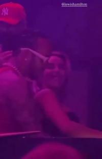 Lewis Hamilton with a woman in a nightclub.