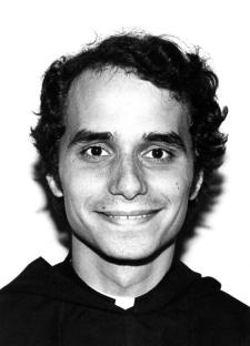 Black and white portrait of a young man with curly hair, wearing a clerical collar.