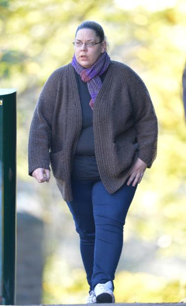 Woman walking in a park.
