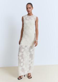 Woman in a white floral maxi dress.