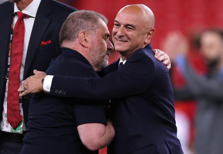 Daniel Levy and Ange Postecoglou embracing after a soccer match.