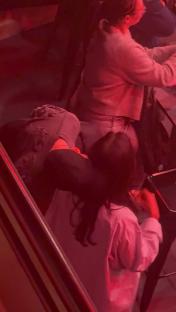 Ruben Dias and Maya Jama cuddling at a football match.