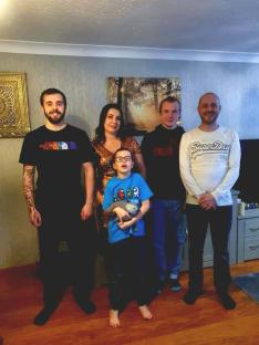 Family photo of a father, mother, and three sons.